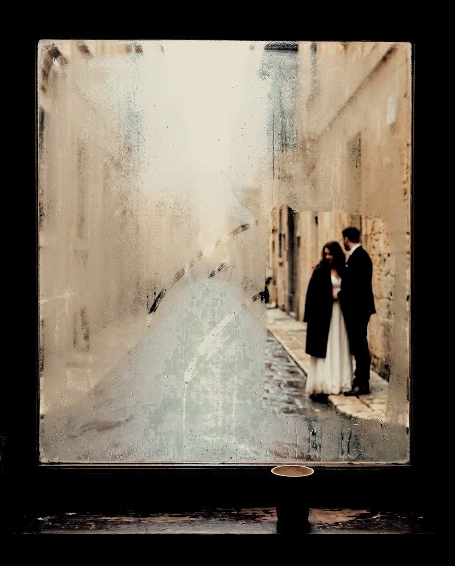 A couple walking in a wet street seen through a misted window, developed in Analog Signature