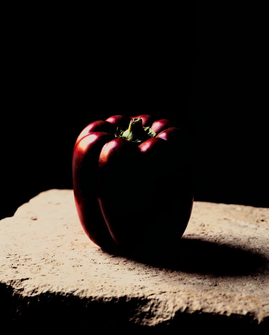 A red pepper on a stone in hard side light, developed in Analog Signature