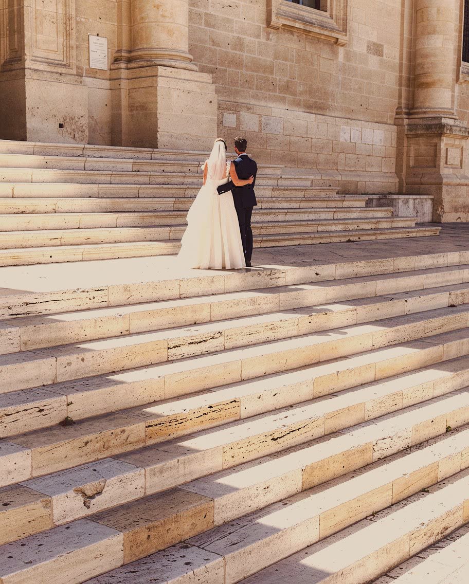 A couple on sunlit limestone steps in Valletta, developed in Analog Signature